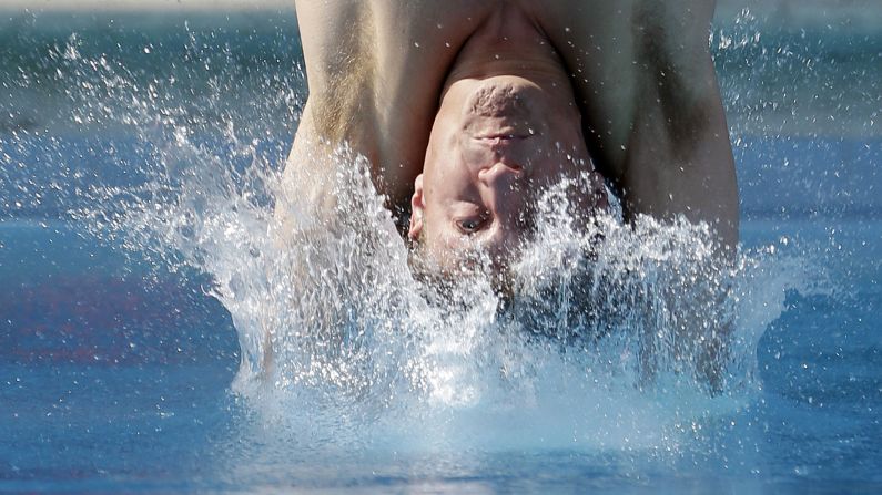 Dwight Dumais hits the water as he competes in the preliminary round of the men's 3-meter springboard event at the USA Diving Grand Prix on May 10 in Fort Lauderdale, Florida.