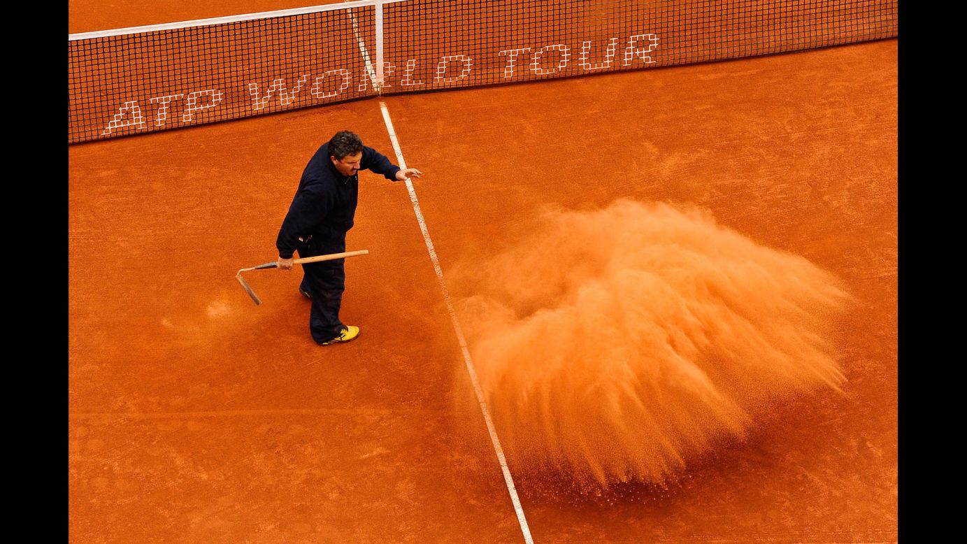 A staff member throws clay on the court during the final match on day seven of the 2013 Barcelona Open Banc Sabadell on April 28 in Barcelona. Rafael Nadal won 6-3, 6-4.