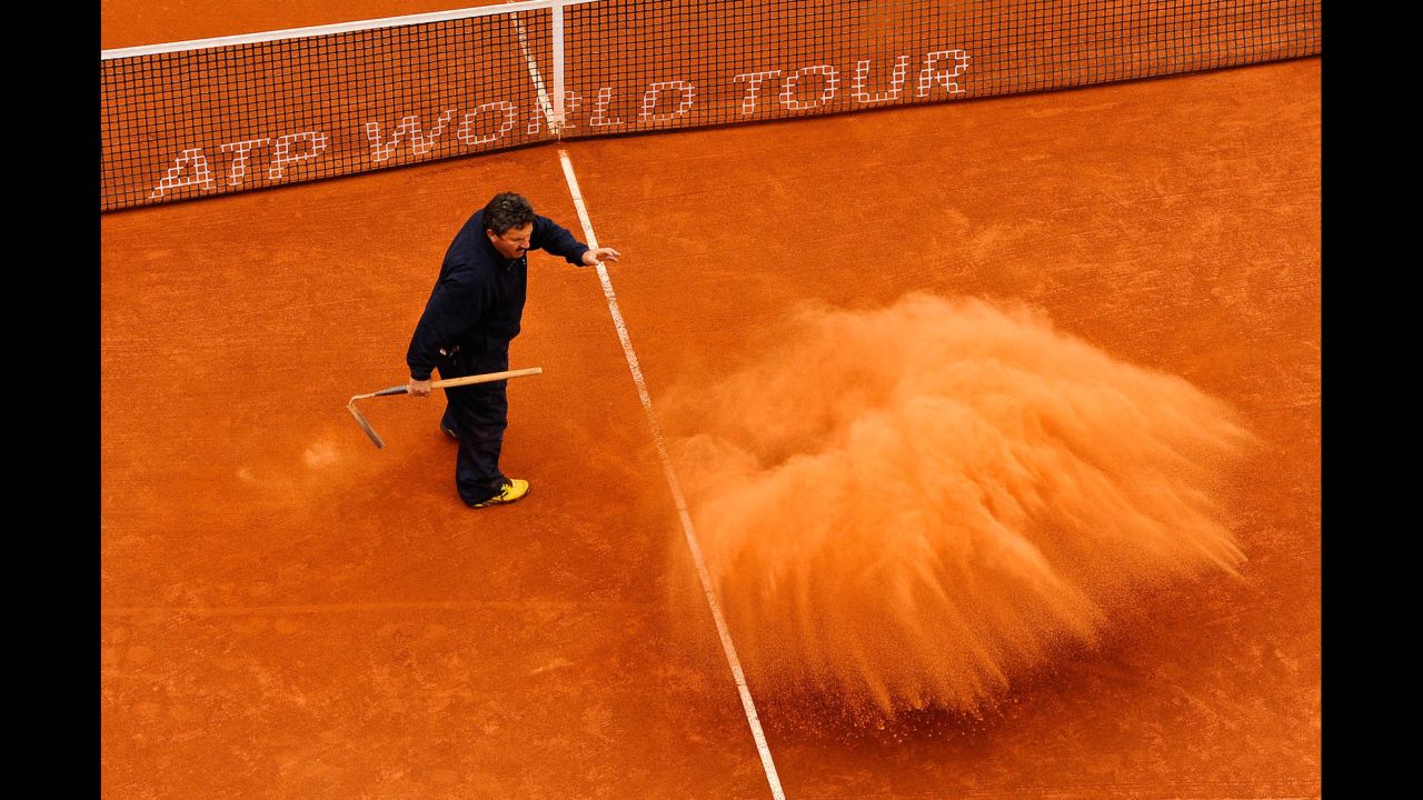 A staff member throws clay on the court during the final match on day seven of the 2013 Barcelona Open Banc Sabadell on April 28 in Barcelona. Rafael Nadal won 6-3, 6-4.