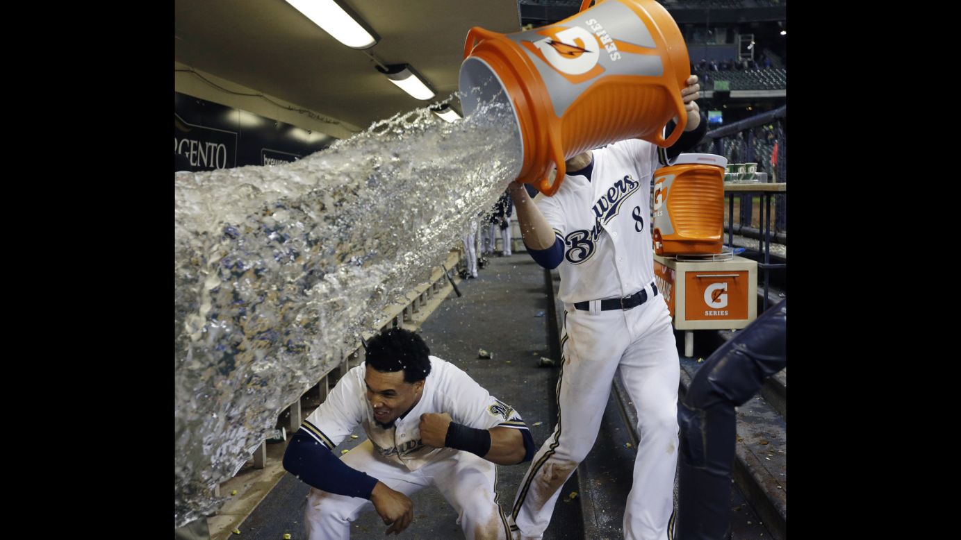 Carlos Gomez of the Milwaukee Brewers ducks out of the way as teammate Ryan Braun tries to soak him with water after a game against the San Francisco Giants on April 17 in Milwaukee. The Brewers won 4-3.