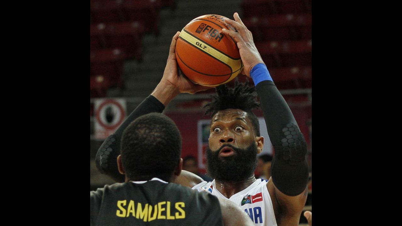 Yack Martinez of the Dominican Republic moves the ball past Jamaica's Samardo Samuels during a FIBA World Cup qualifying game on September 5 in Caracas, Venezuela.