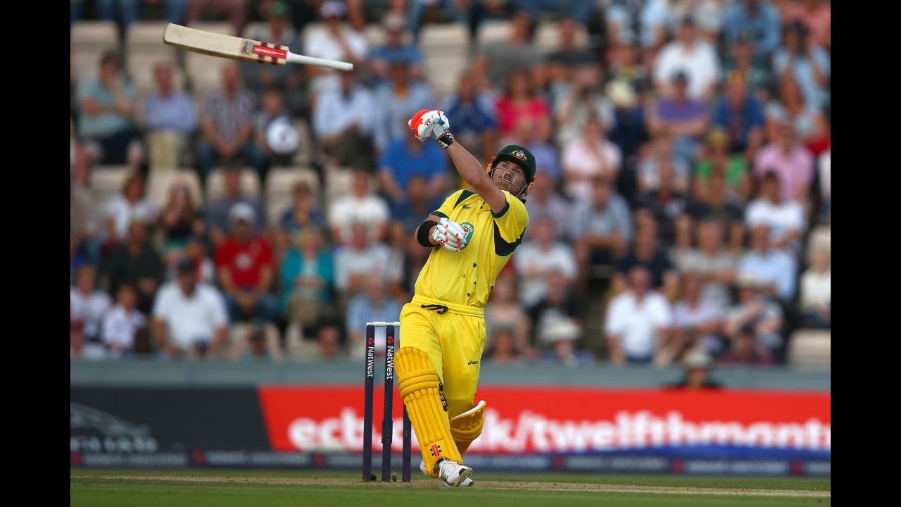 David Warner of Australia lets go of his bat as he hits the ball only to be caught out by Jos Buttler of England during the 1st NatWest Series T20 match between England and Australia on August 29 at the Ageas Bowl in Southampton, England.