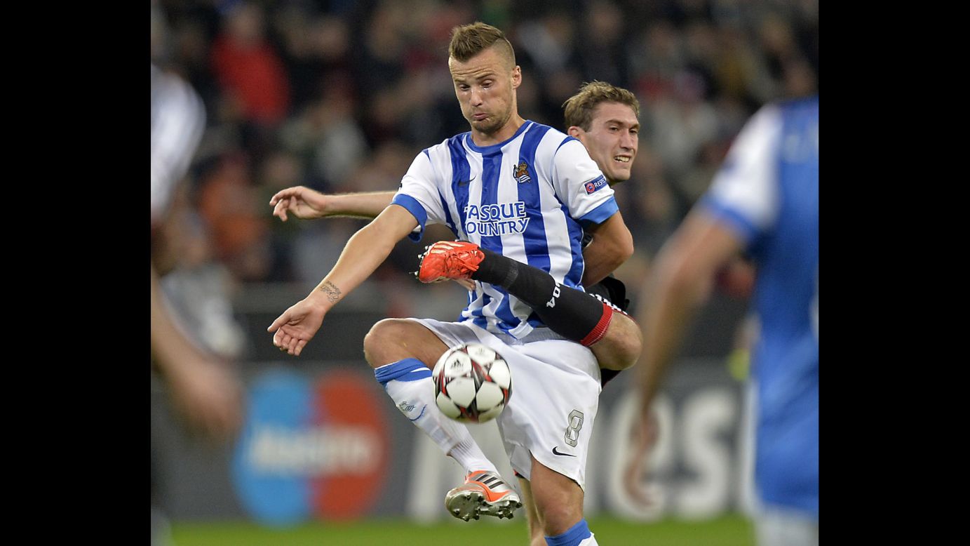 Real Sociedad's Haris Seferovic, front, and Bayer Leverkusen's Stefan Reinartz challenge for the ball during a Champions League Group A soccer match on October 2 in Leverkusen, Germany.
