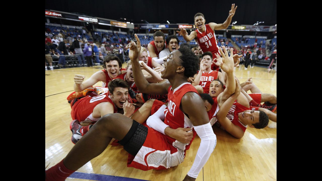 Mater Dei players celebrate after defeating Archbishop Mitty 50-45 in the CIF Boys Open Division State Basketball Championship game on March 23 in Sacramento, California.