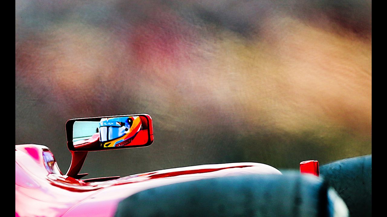 Spanish Formula One driver Fernando Alonso of Scuderia Ferrari is reflected in the mirror on May 11 during the third practice session at the Circuit de Catalunya in Montmelo near Barcelona.