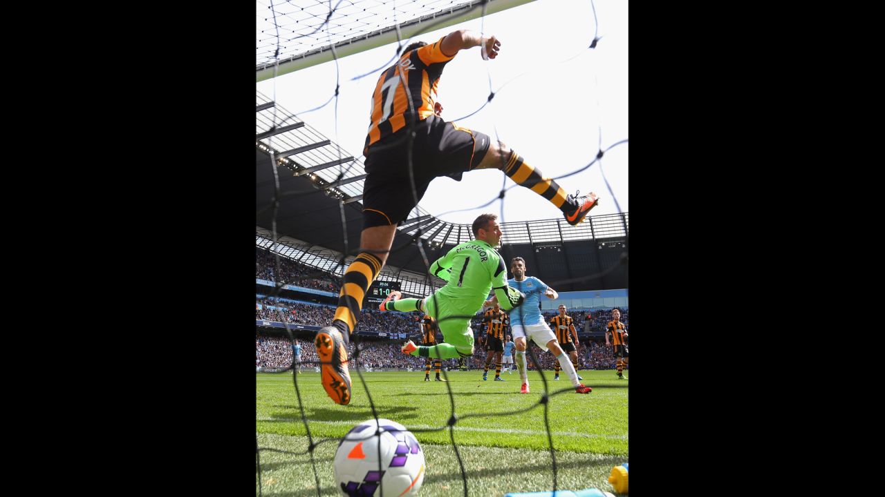 Allan McGregor and Ahmed Elmohamady of Hull City are unable to stop a free kick from Yaya Toure of Manchester City (not pictured) for the second goal during the Barclays Premier League match on August 31 in Manchester, England.