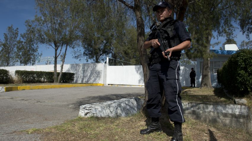 Federal policemen stand guard in front of the National Institute for Nuclear Research (ININ) --the destination of the truck transporting a 'teletherapy source' containing cobalt-60 which was stolen by gunmen on December 2-- in Maquixco, Mexico state on December 4, 2013. Mexican authorities scrambled Wednesday to find a truck containing 'extremely dangerous' radioactive material used in medical treatment. Mexico's National Commission for Nuclear Safety and Safeguards (CNSNS), which reported the theft to the IAEA, said the material posed no risk provided it was not broken or tampered with. AFP PHOTO/ Yuri CORTEZ (Photo credit should read YURI CORTEZ/AFP/Getty Images)
