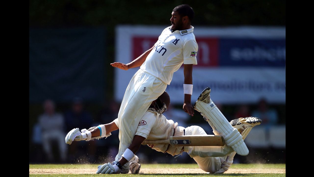Arun Harinath of Surrey collides headfirst with Jeetan Patel of Warwickshire during Day 3 of their LV County Championship Division One match in Guildford, England, on June 7.
