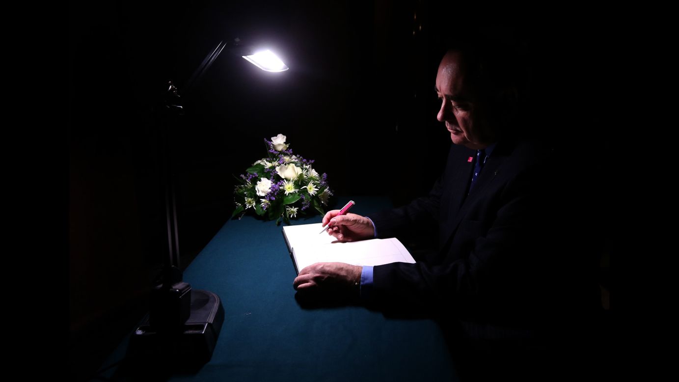 <strong>December 3:</strong> Scottish First Minister Alex Salmond signs a book of condolence at Glasgow City Chambers for those who died when a police helicopter crashed into a busy pub in Glasgow, Scotland. At least nine people were killed and 14 were seriously injured.