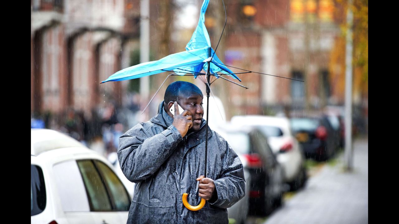 <strong>December 5:</strong> A man holds a broken umbrella in Utrecht, Netherlands, as heavy storms move across northwestern Europe.