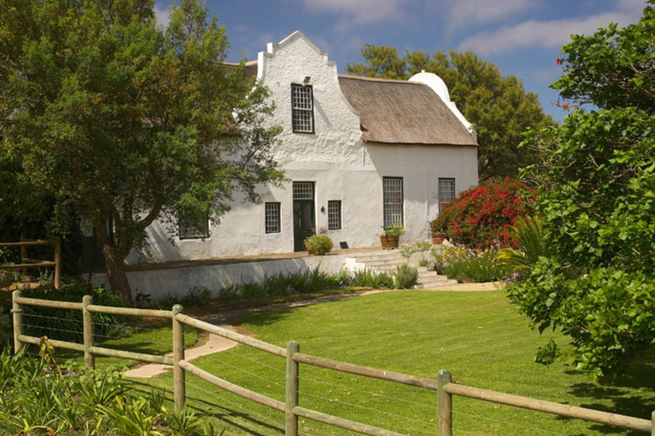 Listed as a national monument, this 18th-century farmhouse is an almost perfectly preserved example of Cape Dutch architecture, down to the original ceilings and fireplaces installed by a former Cape Governor.