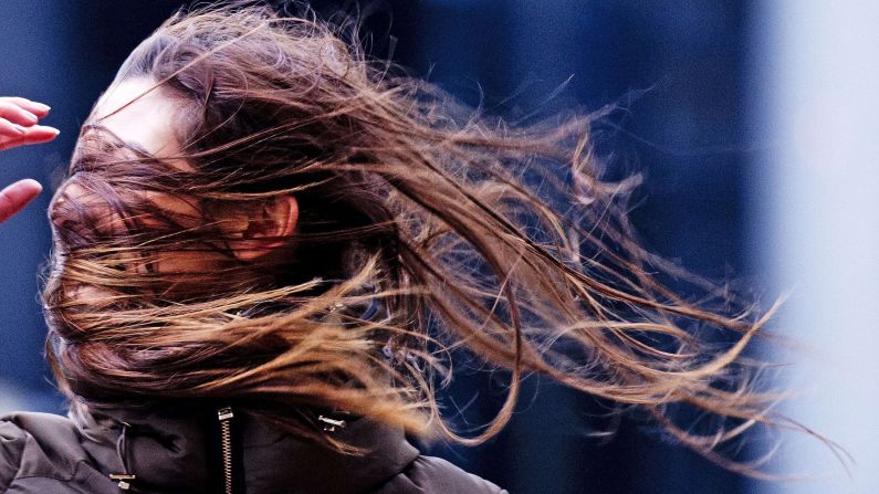 A woman struggles against the wind in Rotterdam, Netherlands, on Thursday, December 5. Large storms with gale winds up to 90 mph are moving across northwestern Europe, causing disruptions in rail and road traffic.