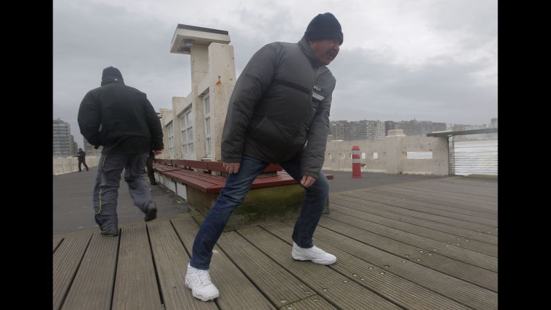 People fight against strong winds on a pier in Blankenberge, Belgium, on December 5.