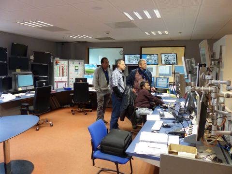 Physicists work in the CMS control room. 