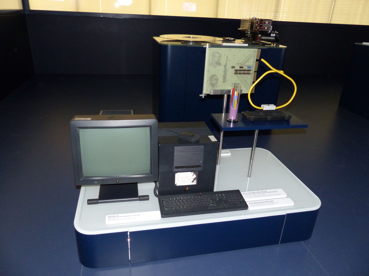 One of the world's first web servers, a NeXT computer from 1991, is seen at CERN. The handwritten note indicates, "This machine is a server. DO NOT POWER DOWN!" On the right is an old Ethernet cable, which can handle only 10 Mb/second, and was largely replaced by the mid-'90s. 