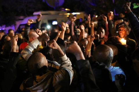 South Africans pay tribute to Mandela in Johannesburg following his death December 5.