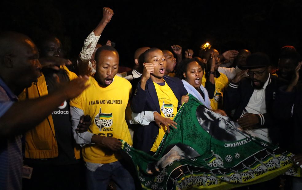 South Africans sing as they pay tribute to Mandela in Johannesburg on December 5.