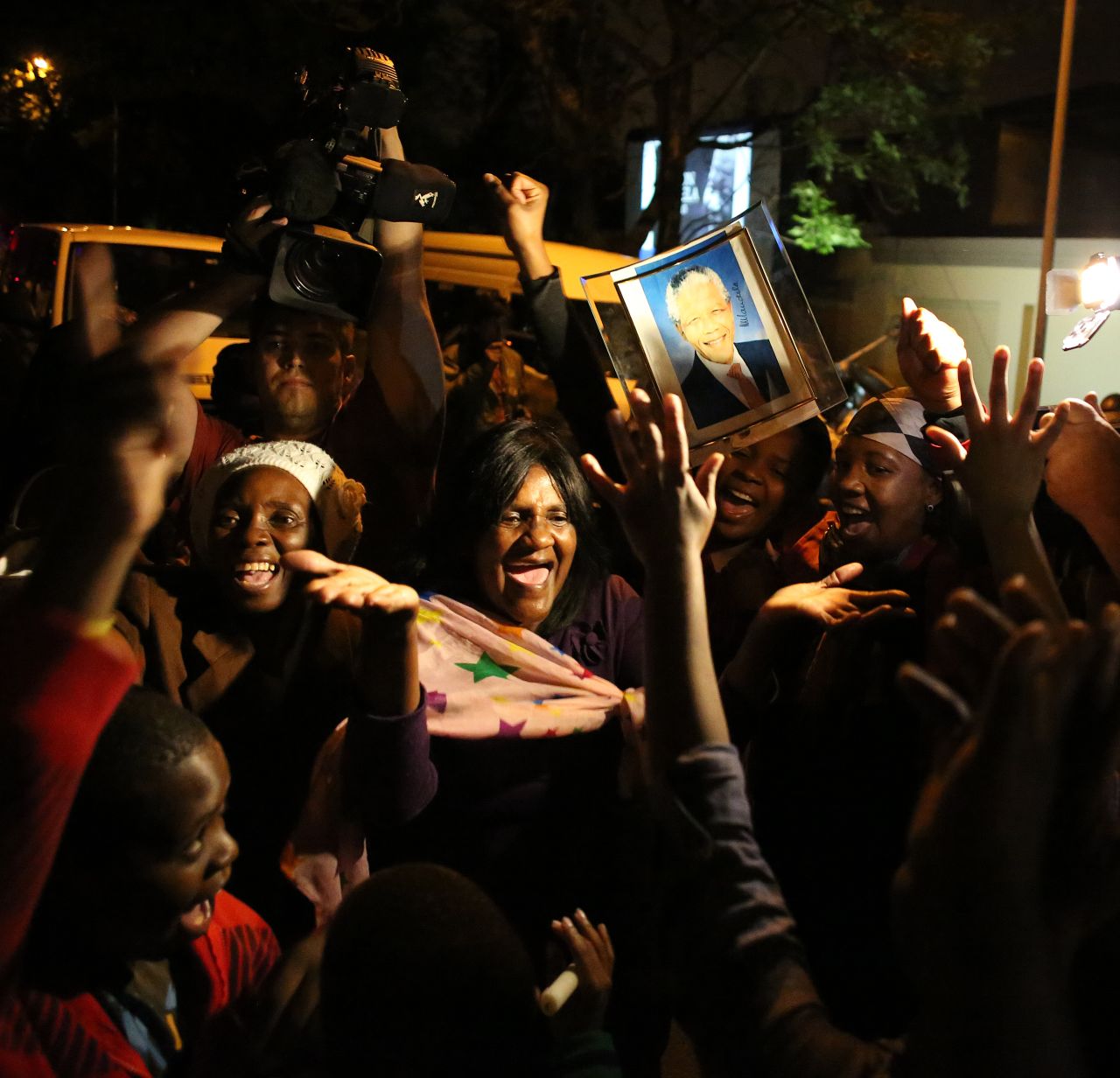 DECEMBER 6 - JOHANNESBURG, SOUTH AFRICA: Mourners sing, dance and cheer in tribute to Nelson Mandela. The revered statesman who emerged from prison after 27 years <a href="http://www.cnn.com/2013/12/05/world/africa/nelson-mandela-apartheid/index.html?hpt=hp_c2">to lead South Africa</a> out of decades of apartheid, <a href="http://www.cnn.com/2013/12/05/world/africa/nelson-mandela/index.html?hpt=hp_t1">has died aged 95</a>. Announcing his death, the <a href="http://www.cnn.com/video/?/video/world/2013/06/25/sot-sabc-zuma-nelson-mandela-death-announcement.sabc-pool&video_referrer=http%3A%2F%2Fwww.cnn.com%2FSPECIALS%2Fafrica%2Fnelson-mandela%2Findex.html">country's president Jacob Zuma said</a>: "Our nation has lost its greatest son. Our people have lost a father."