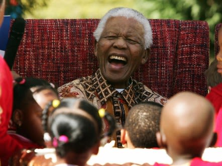 Former South African President Nelson Mandela jokes with youngsters as they celebrate his 89th birthday at the Nelson Mandela Children?s Fund in Johannesburg 24 July 2007