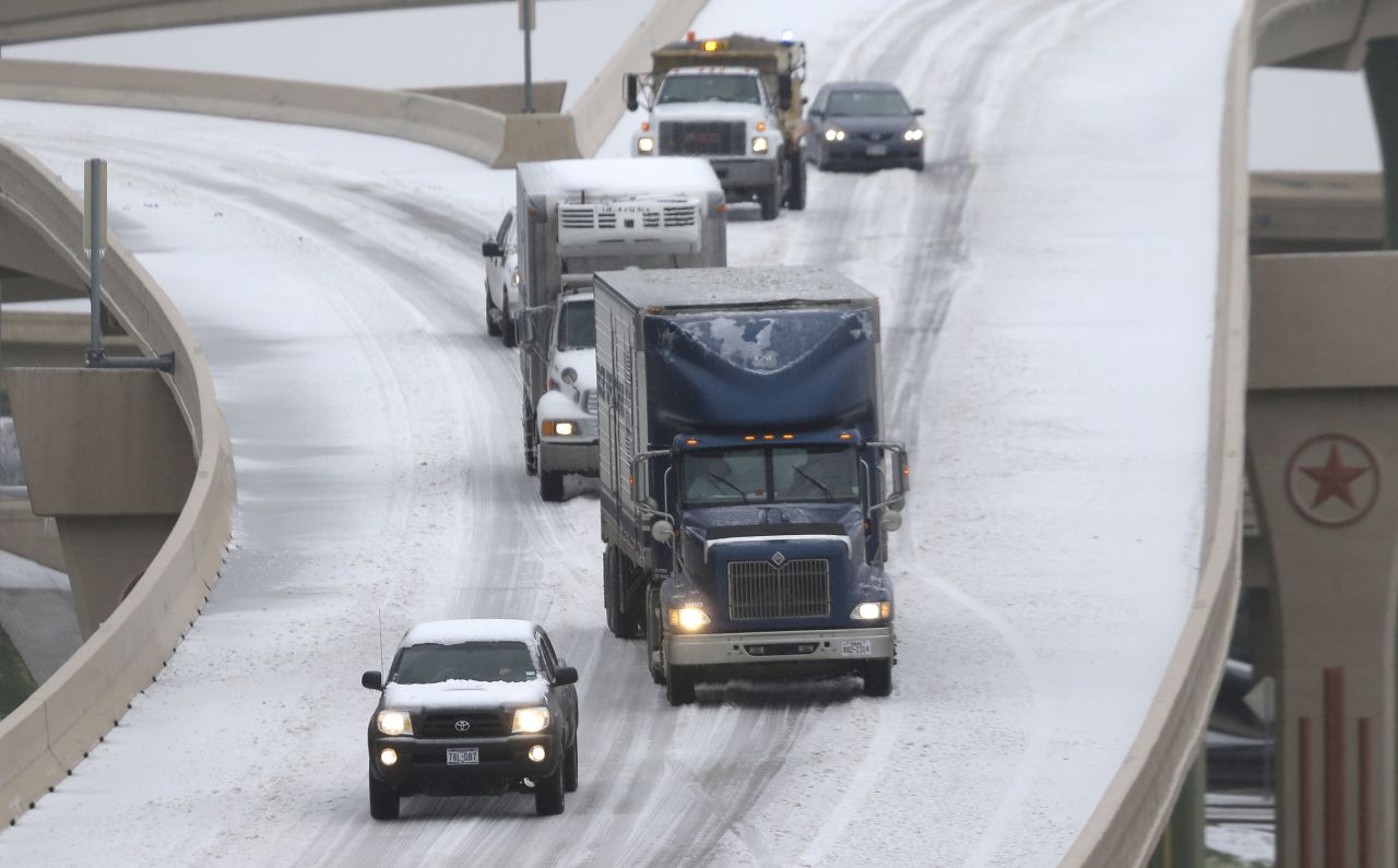 Traffic moves slowly along an ice-covered highway in Dallas on December 6.