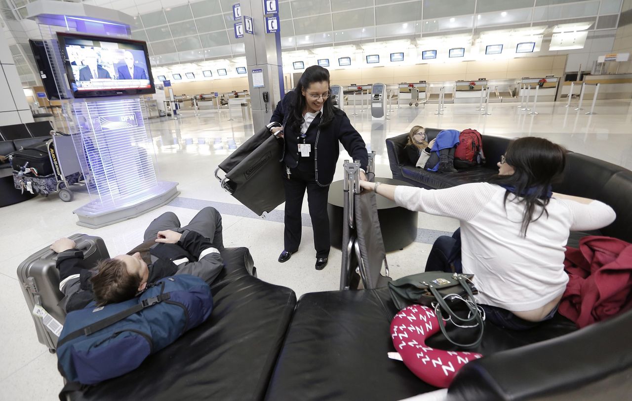 An American Airlines employee hands out cots to stranded airline passengers at Dallas-Fort Worth International Airport on December 5.