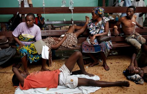 Civilians wait for treatment at Bangui's hospital after a daylong gun battle between Seleka soldiers and Christian militias on December 5.