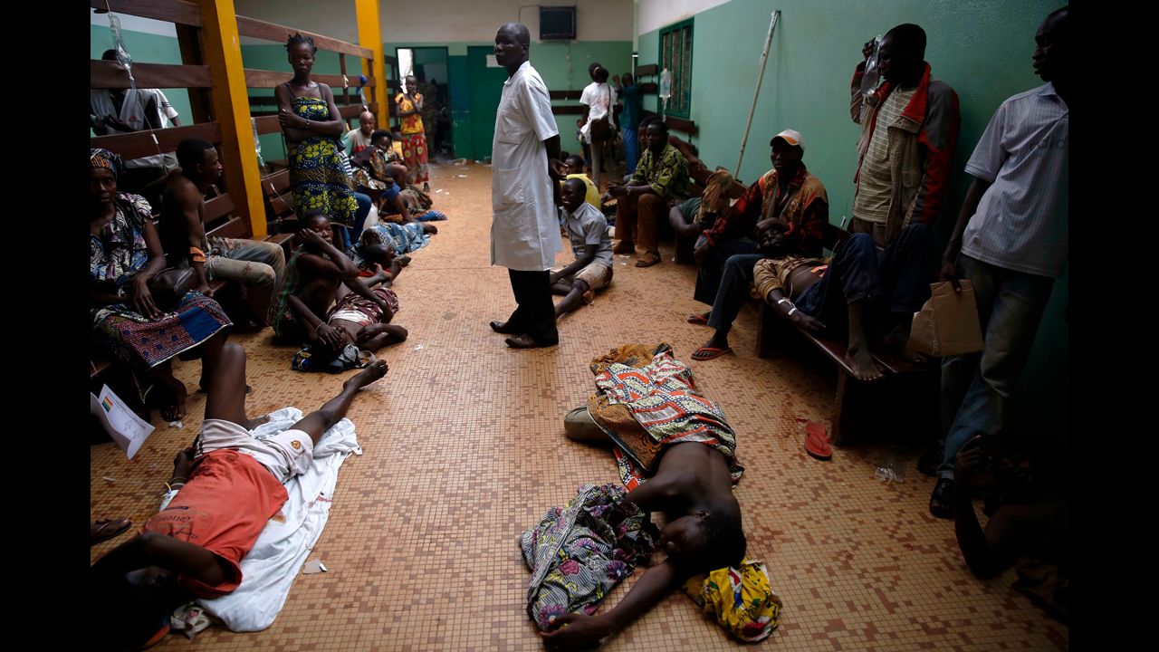 Wounded civilians lie on the floor of Bangui's hospital on December 5.