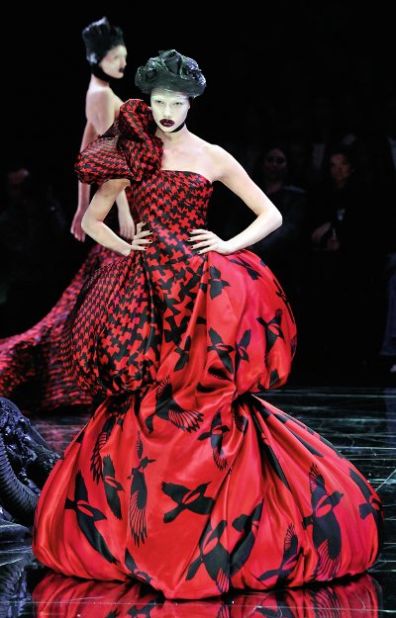 Even before high-profile showings at art fairs, designers have been drawing inspiration from and collaborated with artists for years.  Alexander McQueen's theatrical runway shows blended art, music and film where viewers experienced far more than just a fashion presentation. Here, a model walks down the catwalk in a 2009 show in Paris. 