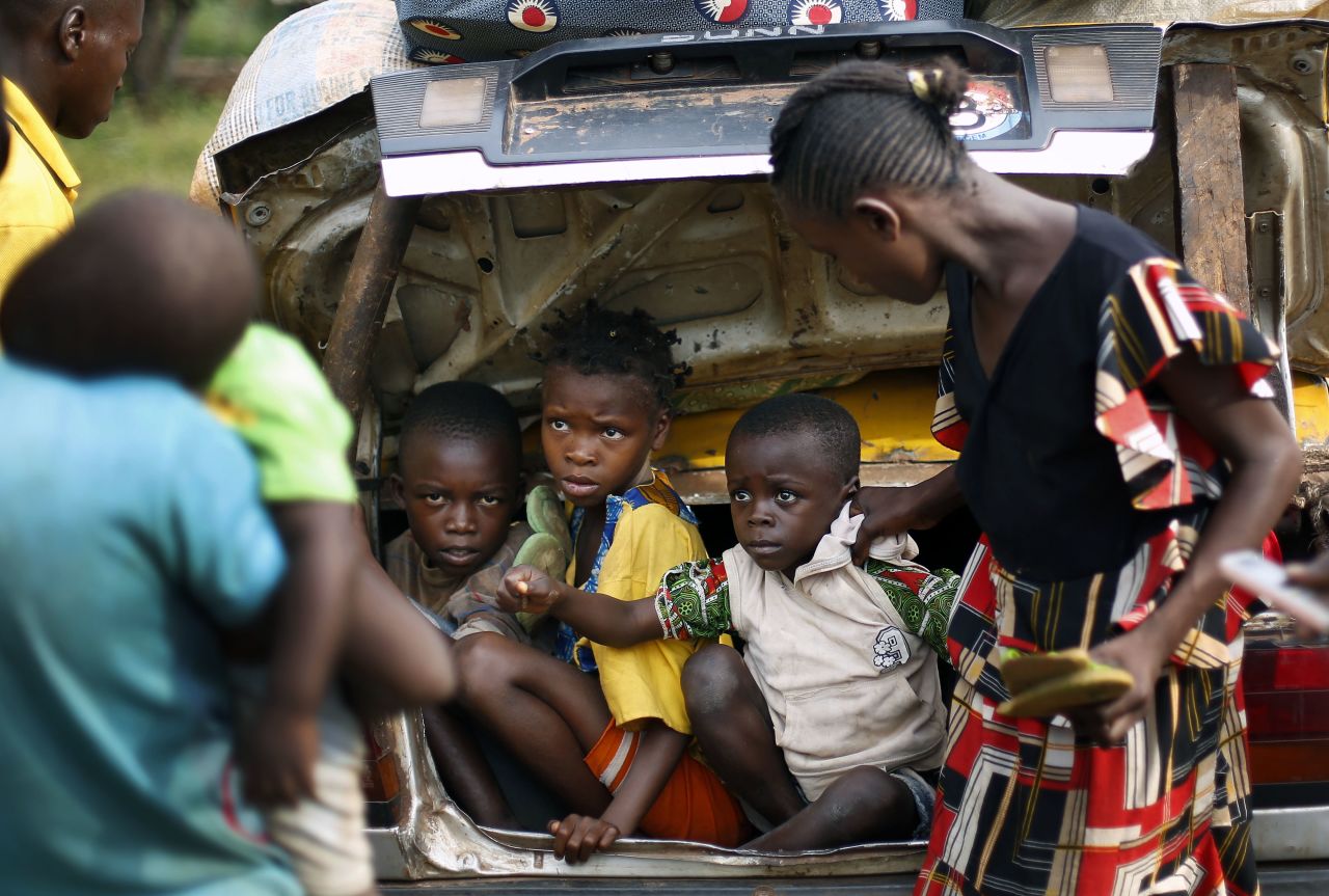 Christian children from Bouebou are packed in the trunk of a taxi as they flee violence December 4. 