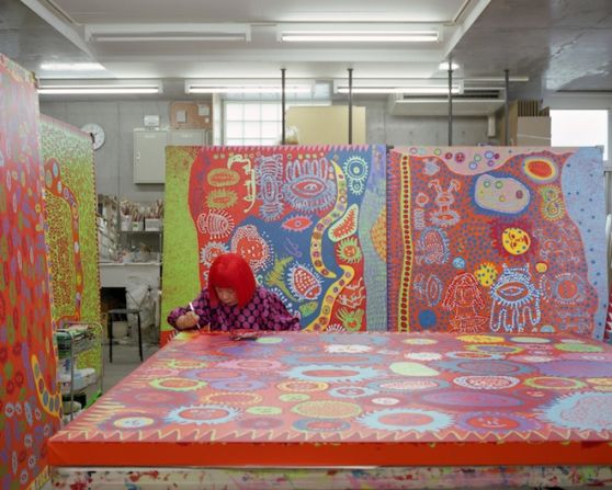 here Kusama is pictured working in her studio. The artist says the kaleidoscopic rooms are her attempt to investigate life, death and infinity.