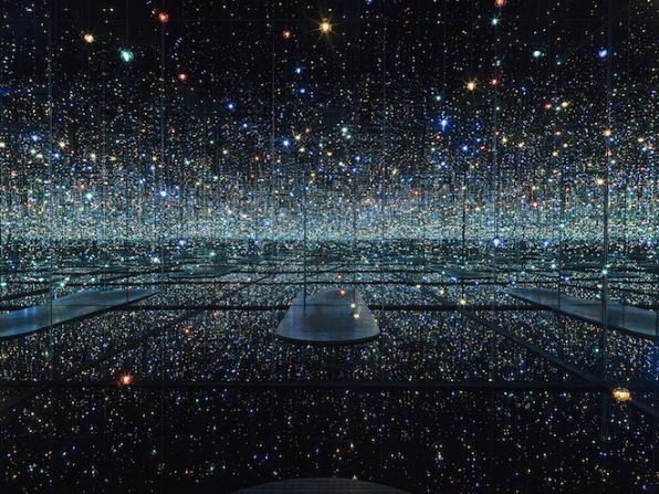 <em>The Souls of Millions of Light Years Away</em> (2013) is Yayoi Kusama's newest infinity mirrored room. Multi-colored LEDs dangle from the ceiling at varying lengths.