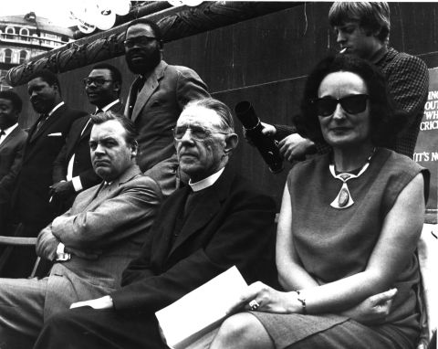 Ruth First (left) was an anti-apartheid activist and investigative journalist. She was exiled from South Africa in 1964, with her husband, prominent South African communist Joe Slovo, and their children. In 1982, while working in Mozambique, First was killed by a letter bomb sent by the South African secret service. First is seen here at the Anti-Apartheid Movement's freedom day rally in London in 1965. 