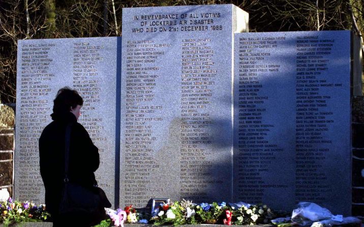 On the 10th anniversary of the bombing, a woman pays her respects in the Garden of Remembrance at Dryfesdale Cemetery in Lockerbie.