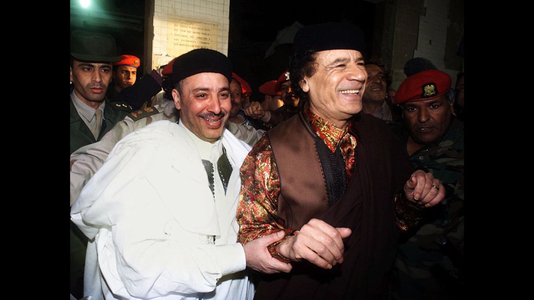 Fhimah, left, walks with Libyan leader Moammar Gadhafi in Tripoli on February 1, 2001, a day after being acquitted.