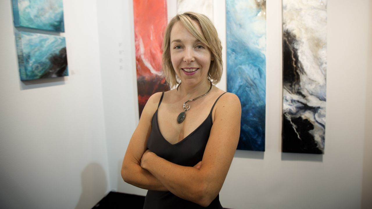 Canadian painter Norah Borden poses in front of some of her work on December 4.