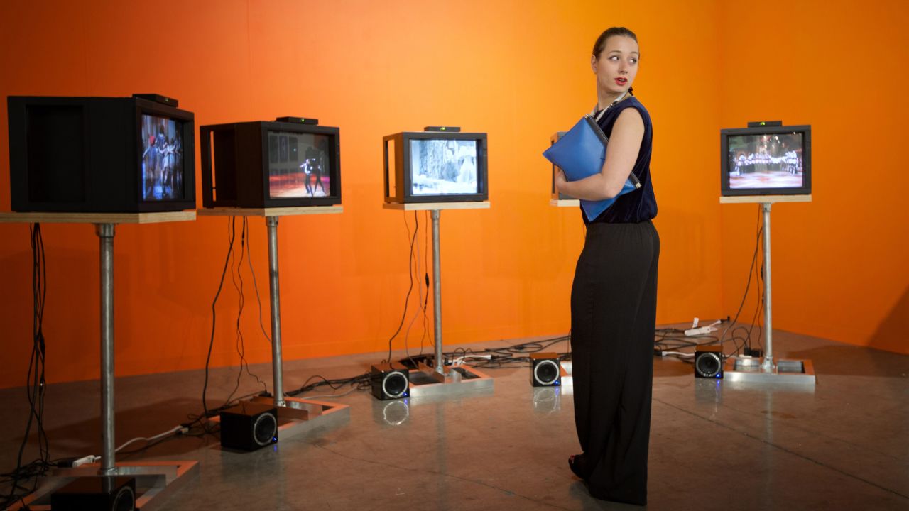 Marina Kurikhina, a Russian art adviser who lives in London, studies a Charles Atlas video installation at Art Basel Miami Beach 2013 on December 4. The video consists of five screens showing a five-channel synchronized work called "Martha, Martha, Martha, Martha, Martha."
