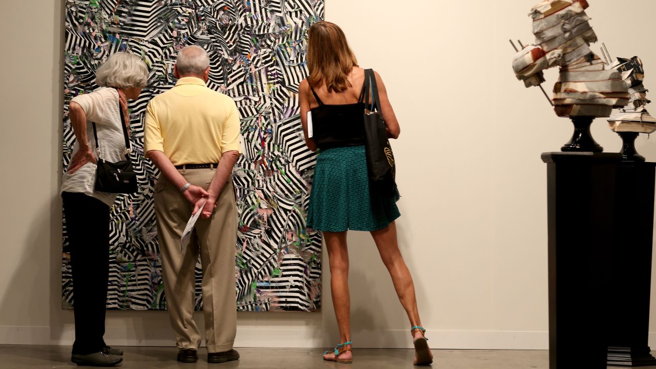 Visitors look at a work by South African artist Zander Blom on December 5.