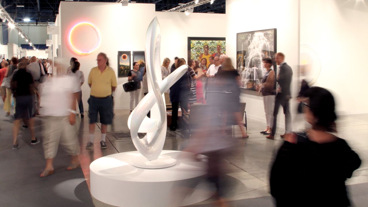 Art lovers move about at Art Basel Miami Beach on December 6, 2013. 