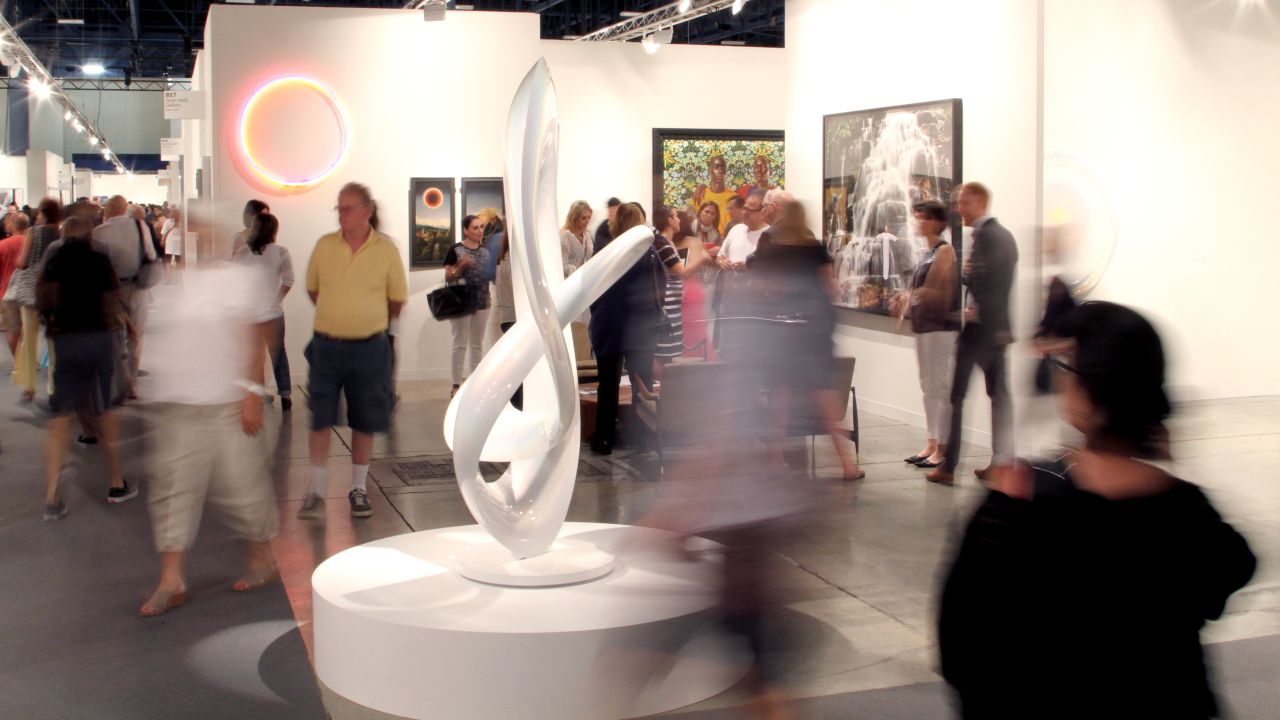 Art lovers move about at Art Basel Miami Beach on December 6, 2013.