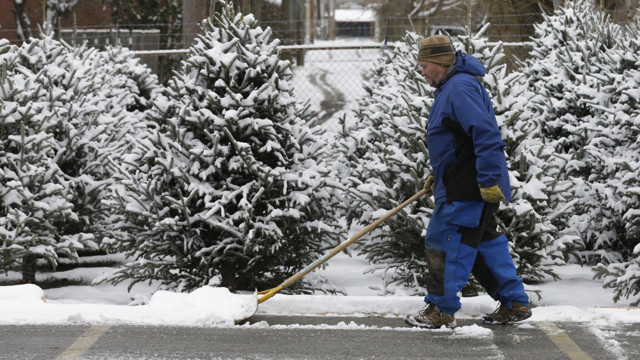 A man clears a path for Christmas tree shoppers in Indianapolis on December 6.