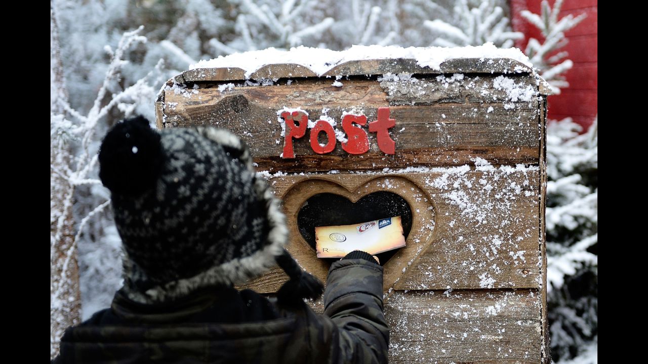 A child posts a letter to Santa in the Elf Village in Ascot, England, on November 30. LaplandUK opened its doors at its new location in Ascot, offering a Christmas experience set in a snow-covered forest with real huskies, reindeer and Father Christmas himself.