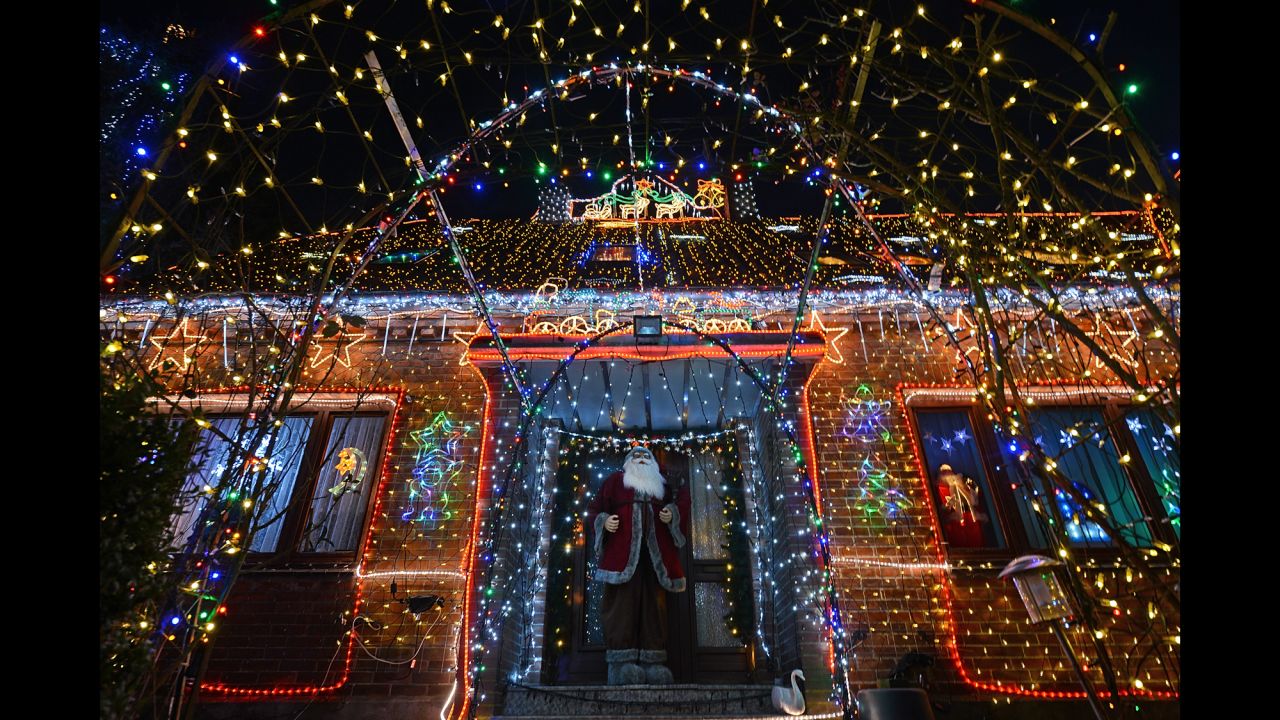 A figure of Santa Claus stands in front of the House of Family Vogt, lit by more than 450,000 lights, on November 30 in Buecken, Germany.