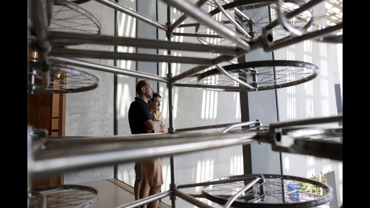 Visitors stand near an installation by Chinese artist Ai Weiwei titled "Stacked," part of the inaugural exhibit at the Perez Art Museum on December 7. The piece features 680 Forever brand bicycles made in China. The museum's new building on Biscayne Bay was designed by Herzog and de Meuron, and the opening was scheduled to coincide with Art Basel.