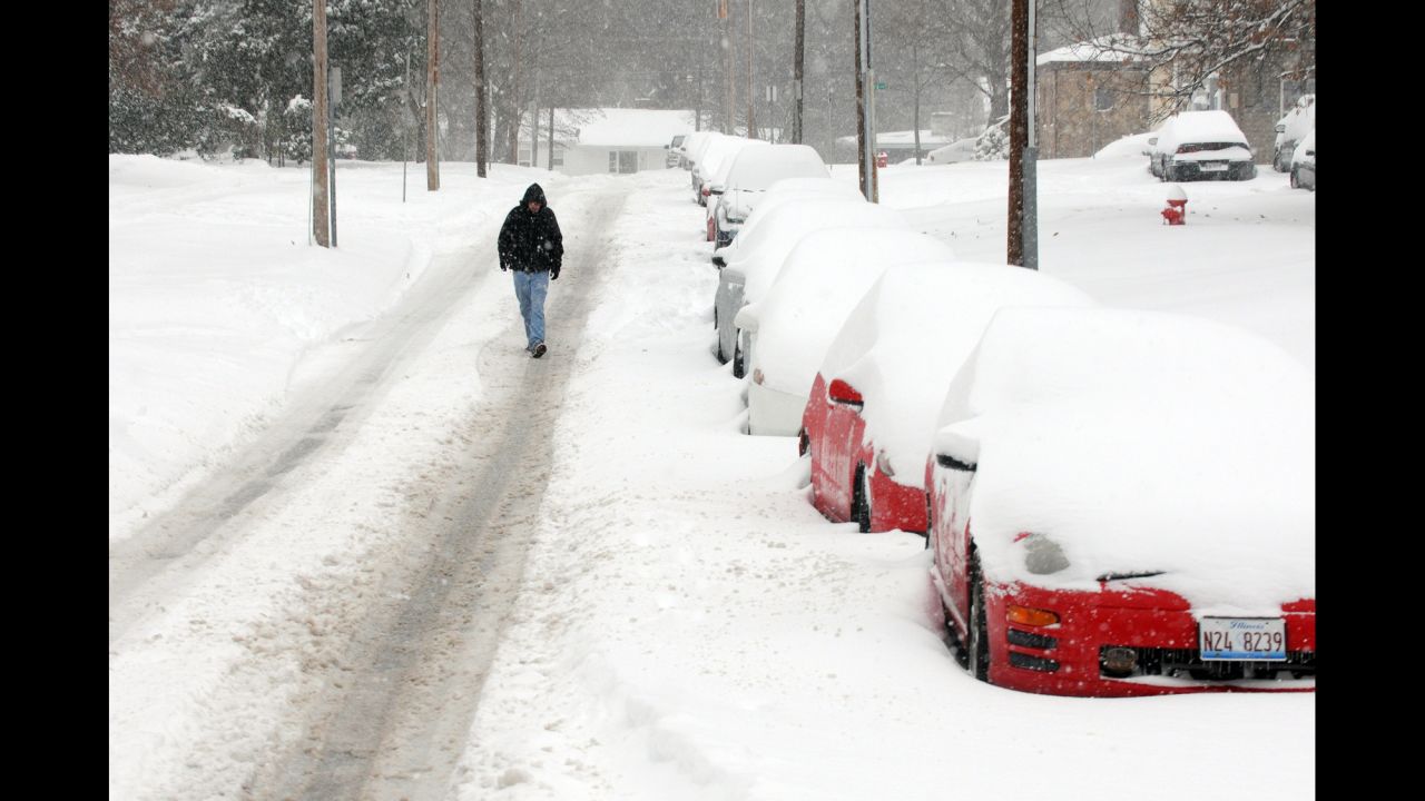 A pedestrian walks down the street after a heavy snowfall on December 6 in Carbondale, Illinois.