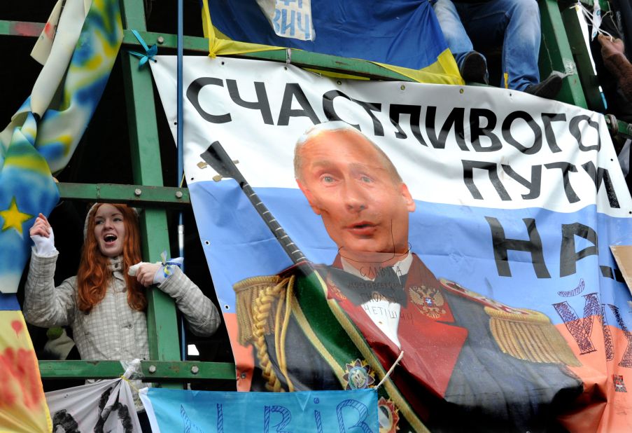 A young protester shouts slogans near a placard depicting Russian President Vladimir Putin and signed "Fare you well!" during the December 8 rally.