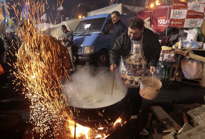 Protesters prepare food at a camp in Independence Square on December 7.