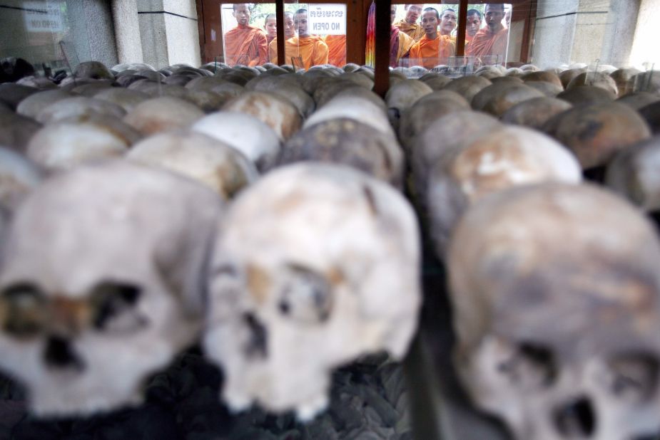 Cambodian Buddhist monks bless victims' skulls at the Choeung Ek Killing Fields memorial in Phnom Penh on April 17, 2008. 