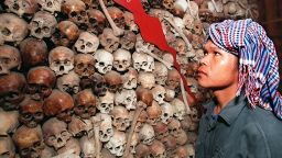 Cambodian Sam Vishna, 28 years, looks at a mixture of brown and white skulls that make up a map of Cambodia at Tuol Sleng (S-21 prison) Museum in Phnom Penh, 9 December.
