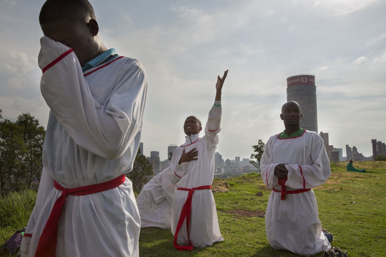 Christians mourning the loss of Mandela say prayers on a hilltop overlooking Johannesburg on December 7.
