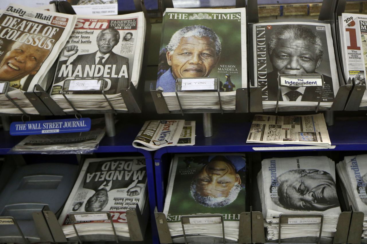 Newspapers with Mandela on the front page are on sale in London on December 6.